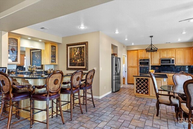 dining room featuring baseboards, stone finish floor, recessed lighting, and visible vents