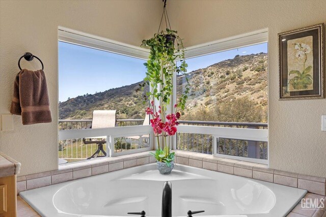 dining room with a textured wall and a mountain view