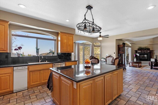 kitchen featuring a ceiling fan, recessed lighting, a sink, and tasteful backsplash
