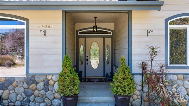 view of exterior entry with a porch