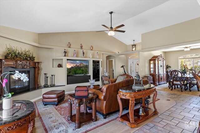 living room with high vaulted ceiling and ceiling fan