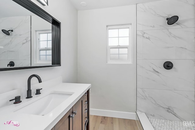 6405 Hesketh Dr, Bakersfield, CA 93309 - bathroom featuring a marble finish shower, wood finished floors, and plenty of natural light