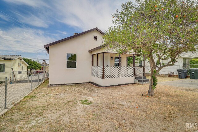 710 Fillmore St, Taft, CA 93268 - bungalow-style house with a porch, stucco siding, and fence