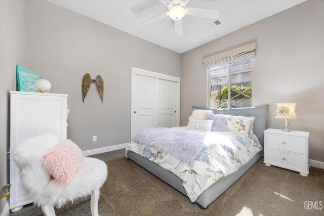 bedroom featuring dark colored carpet, a closet, and ceiling fan