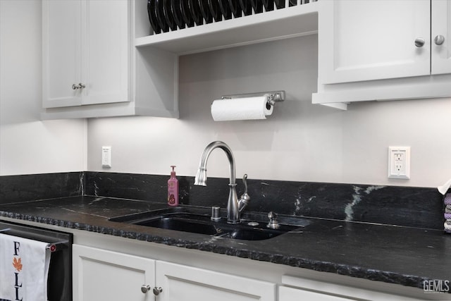 kitchen with white cabinetry, dishwasher, and sink