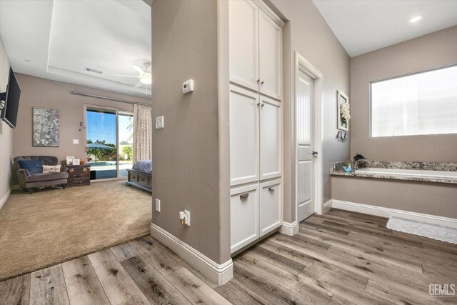 hall with light hardwood / wood-style floors