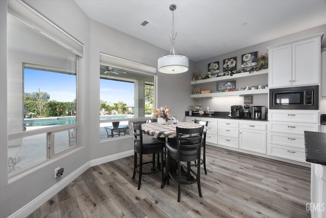 dining space with hardwood / wood-style flooring