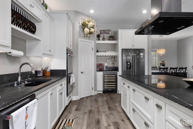 kitchen featuring white cabinetry, beverage cooler, island exhaust hood, dark stone countertops, and high quality fridge