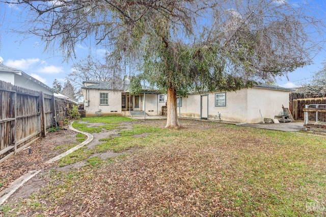 back of house with a lawn