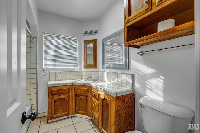 bathroom with vanity, tile patterned flooring, toilet, and decorative backsplash