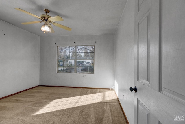 carpeted empty room with ceiling fan