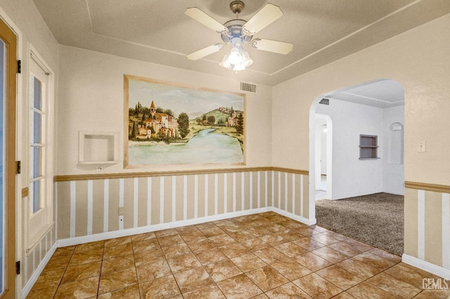 empty room with tile patterned floors and ceiling fan