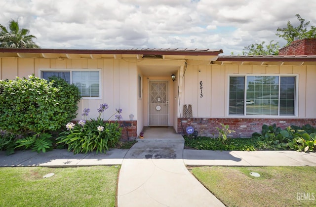 6513 Desmond Ct, Bakersfield, CA 93308 - entrance to property featuring brick siding, board and batten siding, and a chimney