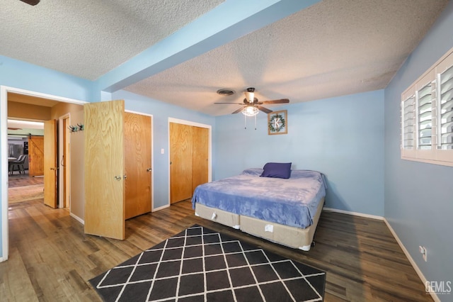 6513 Desmond Ct, Bakersfield, CA 93308 - bedroom featuring a textured ceiling, wood finished floors, two closets, and ceiling fan