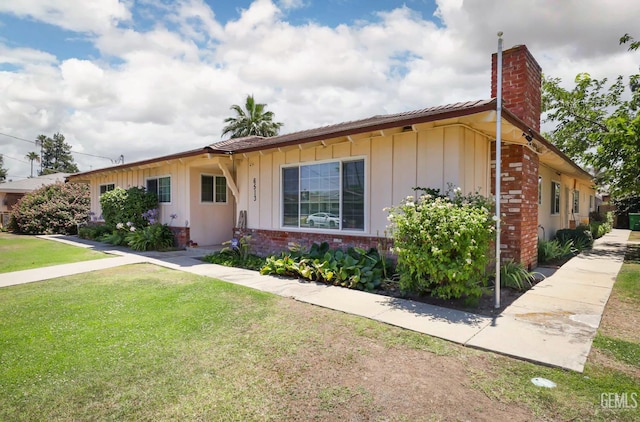 6513 Desmond Ct, Bakersfield, CA 93308 - ranch-style house with a chimney, board and batten siding, brick siding, and a front lawn