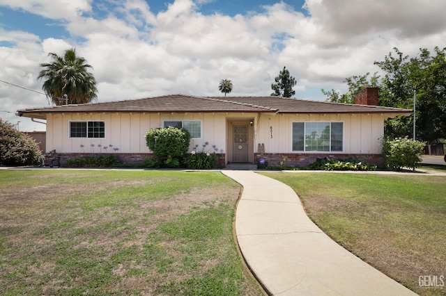 6513 Desmond Ct, Bakersfield, CA 93308 - single story home with a chimney, board and batten siding, a front lawn, and brick siding