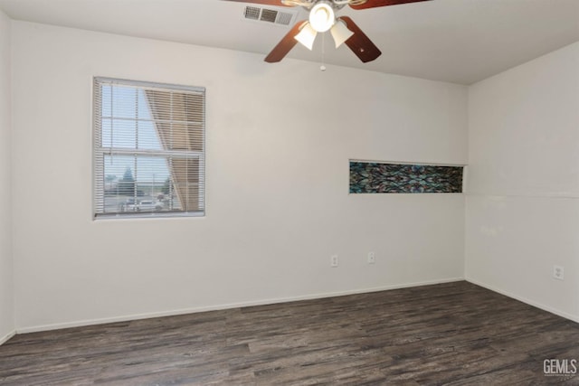 empty room featuring ceiling fan and dark wood-type flooring