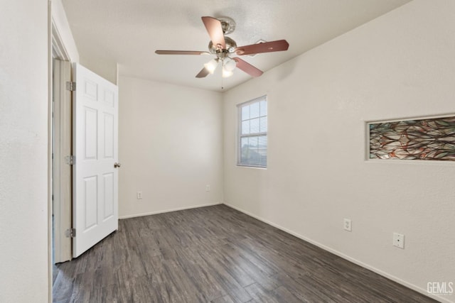 unfurnished bedroom featuring ceiling fan and dark wood-type flooring