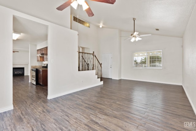 unfurnished living room featuring a textured ceiling, ceiling fan, lofted ceiling, and dark wood-type flooring