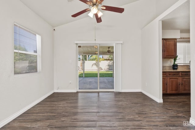 interior space featuring ceiling fan, dark hardwood / wood-style floors, and vaulted ceiling