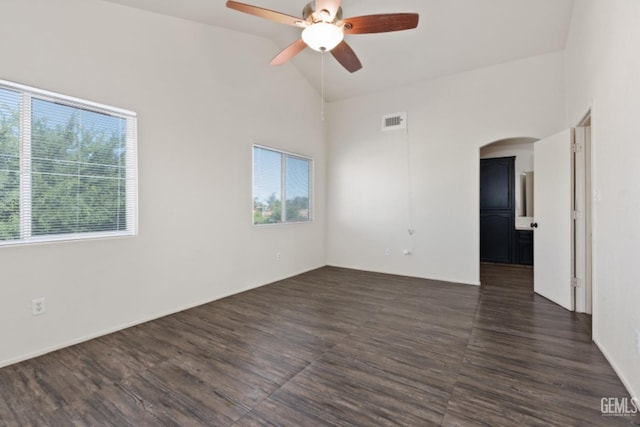 spare room with ceiling fan, a wealth of natural light, and vaulted ceiling