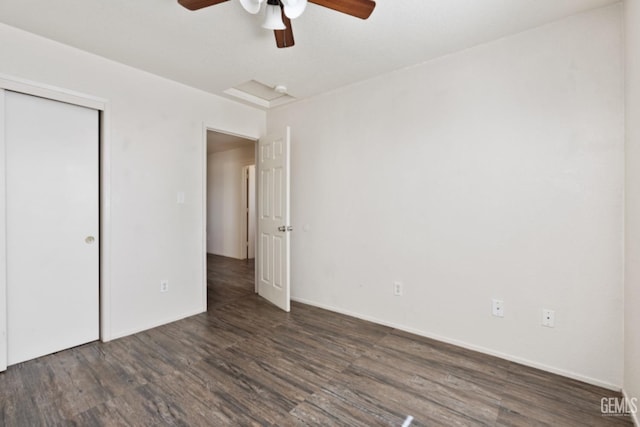 unfurnished bedroom with ceiling fan, dark wood-type flooring, and a closet