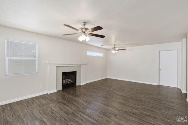 unfurnished living room featuring a textured ceiling, dark hardwood / wood-style flooring, and ceiling fan