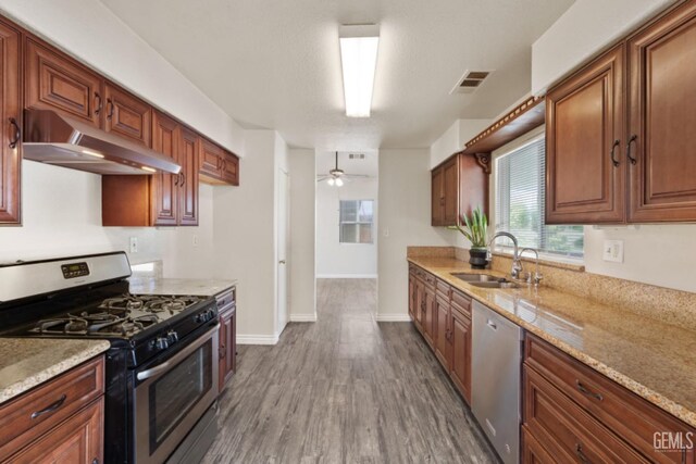 1085 Mast Ave, Mc Farland, CA 93250 - kitchen with ceiling fan, sink, stainless steel appliances, light stone counters, and dark hardwood / wood-style flooring