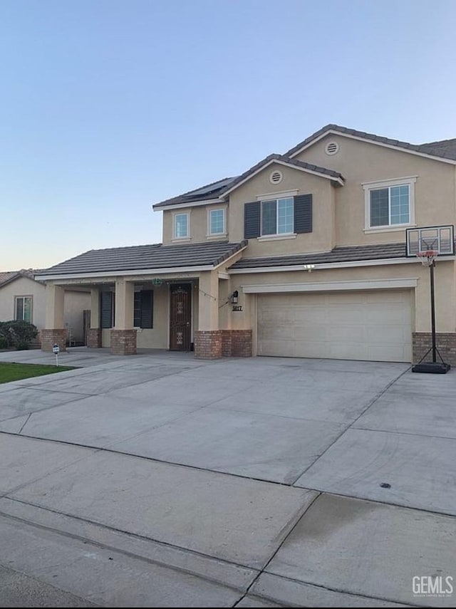 5017 Clear Crystal Dr, Bakersfield, CA 93313 - traditional-style house with a garage, stucco siding, brick siding, and driveway