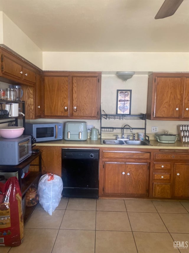 kitchen with brown cabinets, dishwasher, white microwave, and a sink