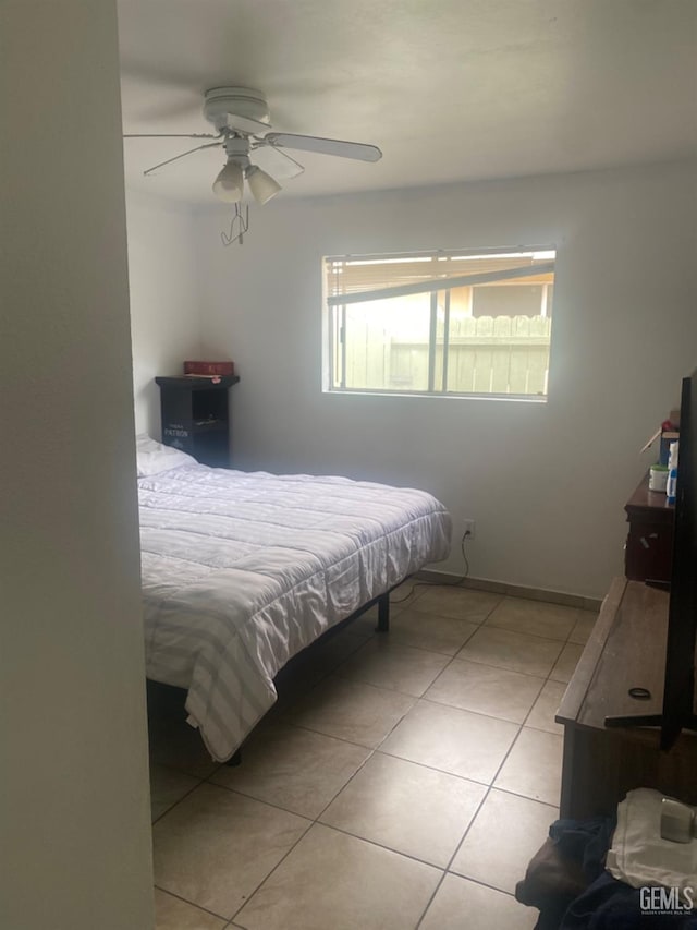 bedroom with light tile patterned floors and a ceiling fan