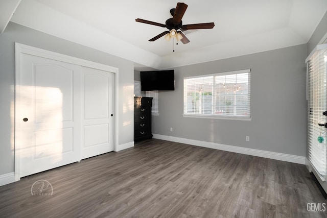 unfurnished bedroom featuring a closet, baseboards, and wood finished floors