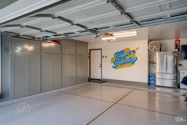 garage with freestanding refrigerator and a garage door opener