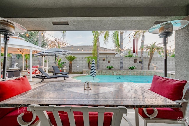 view of pool featuring a patio area, a fenced backyard, and a fenced in pool