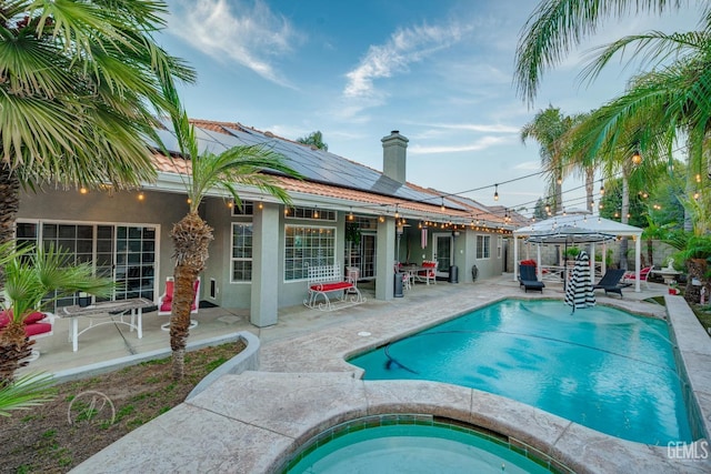 pool featuring a patio area, a gazebo, and an in ground hot tub