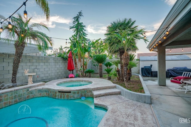 view of swimming pool with a patio area, a fenced backyard, grilling area, and an in ground hot tub