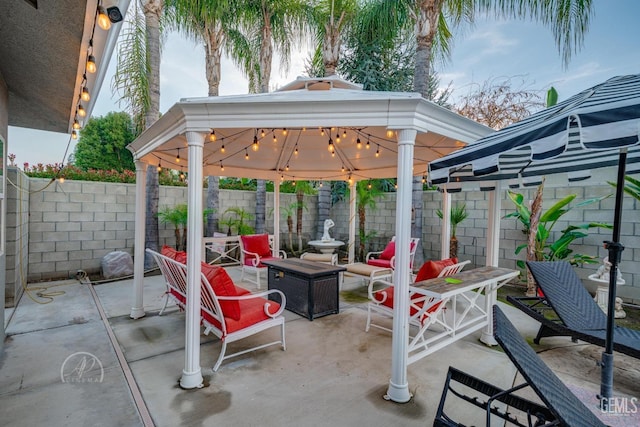 view of patio with a fenced backyard and a gazebo