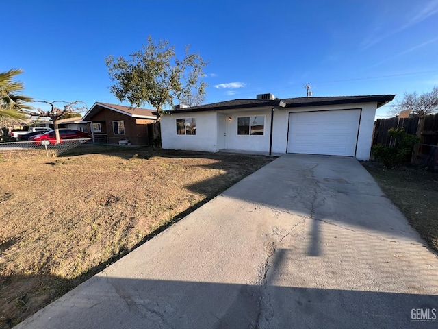 ranch-style house with a garage and a front lawn