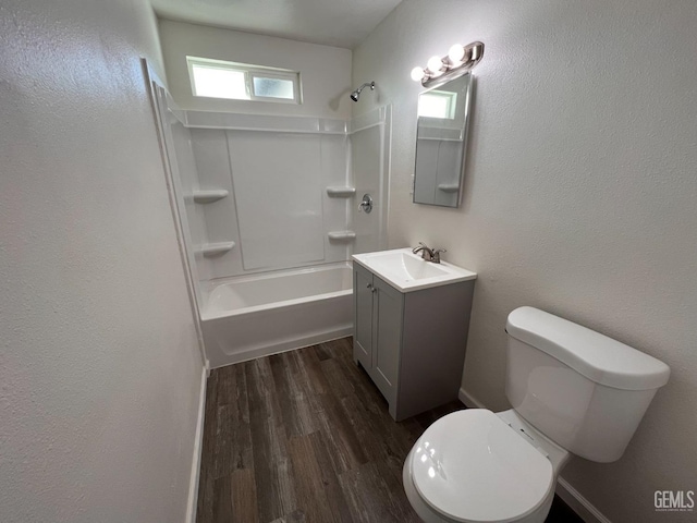 full bathroom with hardwood / wood-style flooring, vanity, shower / bath combination, and toilet