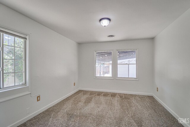 201 Cedar St, Bakersfield, CA 93304 - spare room with light carpet and baseboards