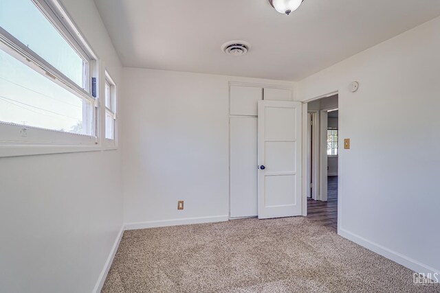 201 Cedar St, Bakersfield, CA 93304 - unfurnished bedroom featuring carpet, baseboards, and a closet