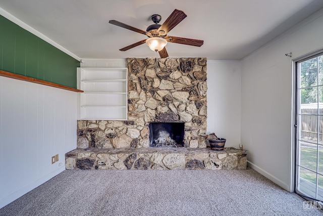 201 Cedar St, Bakersfield, CA 93304 - unfurnished living room featuring carpet, ceiling fan, crown molding, baseboards, and a fireplace