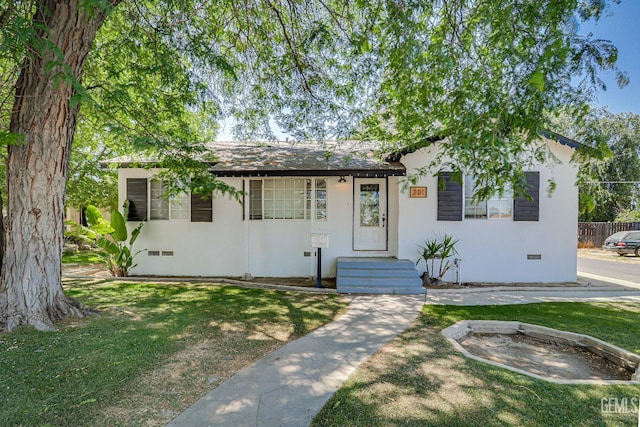 201 Cedar St, Bakersfield, CA 93304 - view of front of home with crawl space, a front yard, and stucco siding
