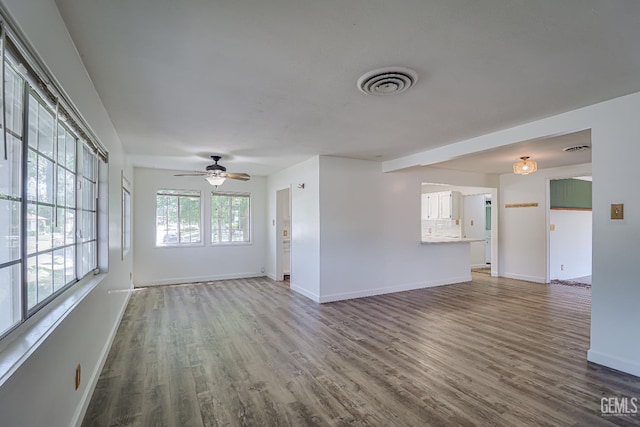 201 Cedar St, Bakersfield, CA 93304 - unfurnished living room with wood finished floors, baseboards, and a ceiling fan