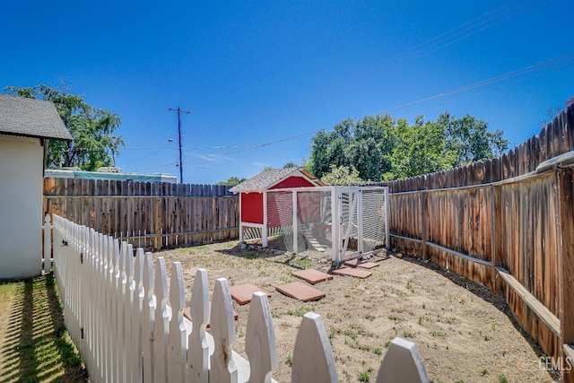 201 Cedar St, Bakersfield, CA 93304 - fenced backyard featuring exterior structure and an outbuilding