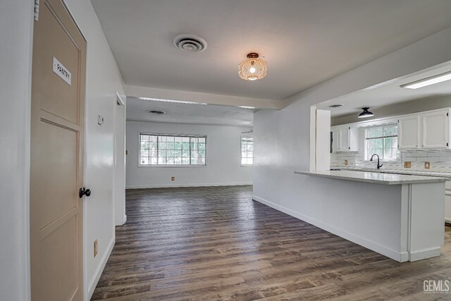 201 Cedar St, Bakersfield, CA 93304 - kitchen with a sink, dark wood-style flooring, white cabinetry, and plenty of natural light