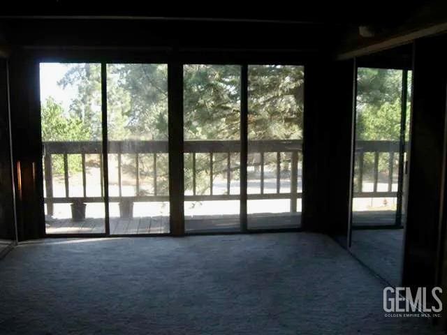 doorway to outside with carpet floors