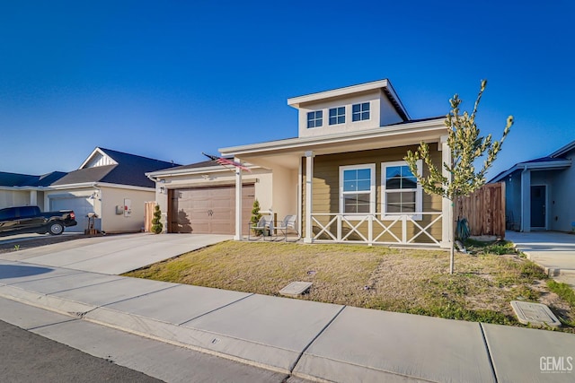 view of front of house featuring an attached garage, covered porch, driveway, stucco siding, and a front lawn