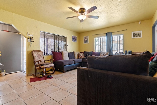 tiled living room featuring ceiling fan and a textured ceiling