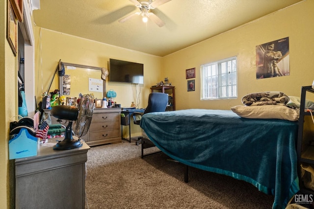 carpeted bedroom with ceiling fan and a textured ceiling